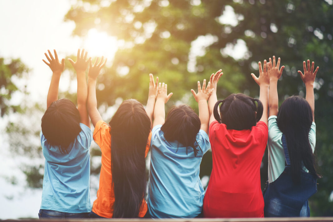 Group of kids friends arm around sitting together Online Course